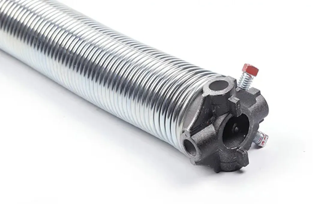 Heavy-duty torsion spring mechanism supporting a commercial overhead sectional door.
