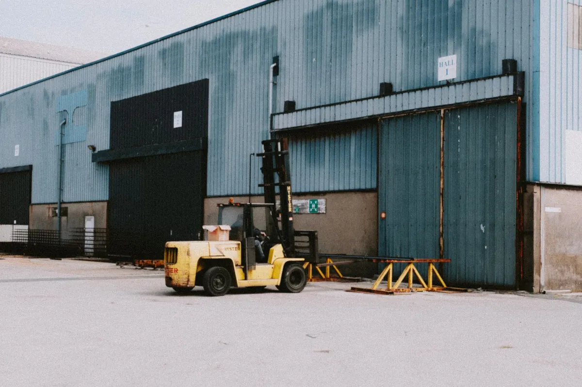 Forklift traffic moving through a transparent industrial barrier