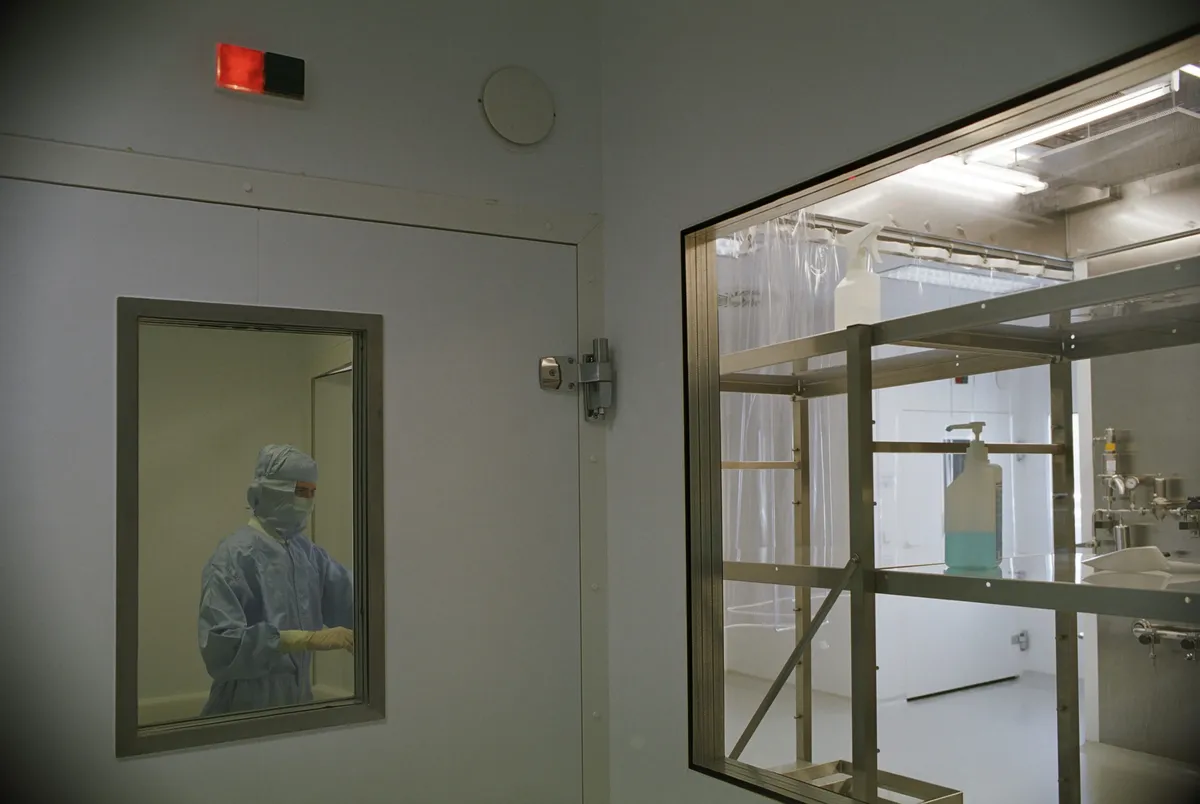 Engineers checking pressure differentials in a sterile cleanroom facility.
