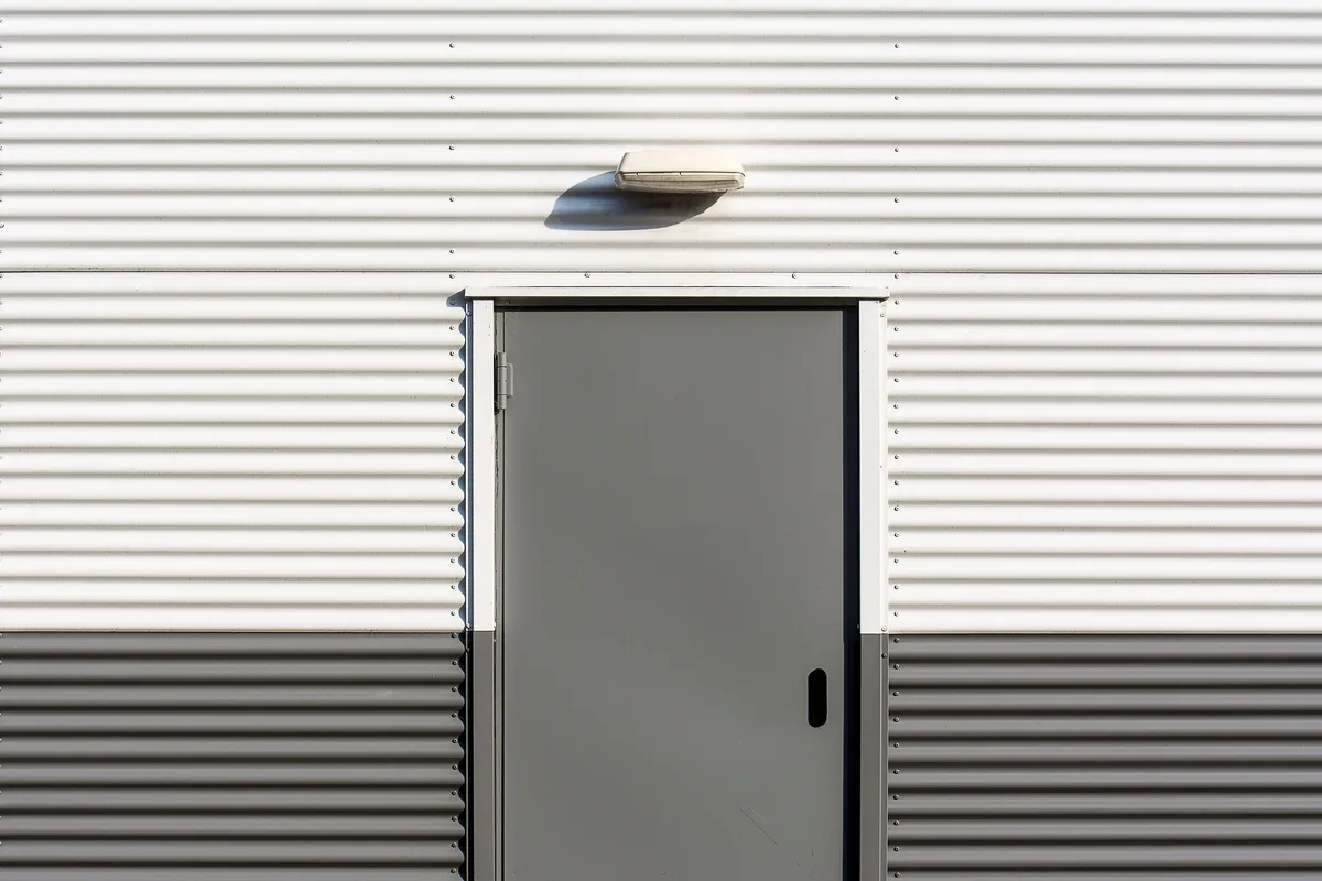 Close-up of a heavy-duty pharmaceutical airtight door showing the robust perimeter sealing mechanism.