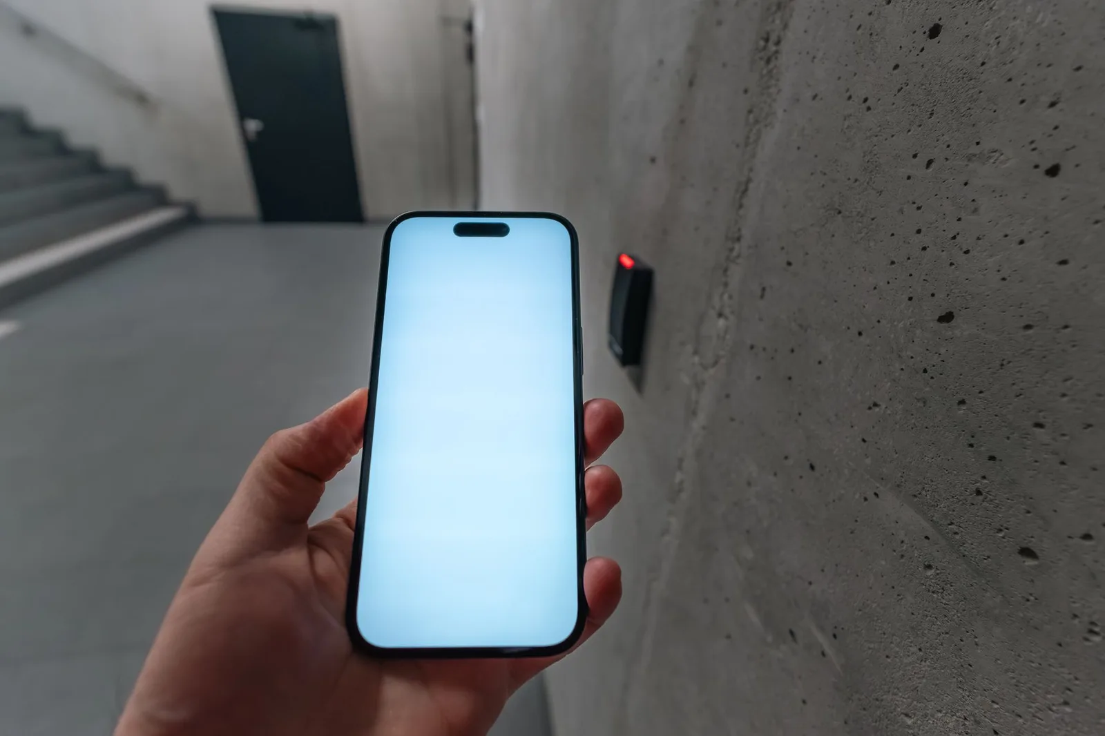 Homeowner controlling automated garage door opener system via smartphone mobile application