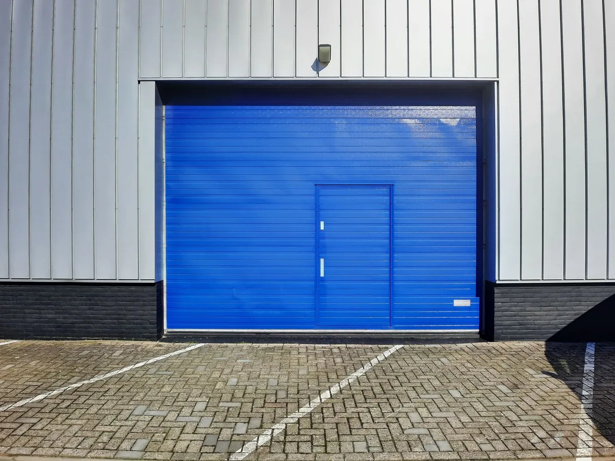 Insulated commercial sectional overhead door in warehouse loading bay