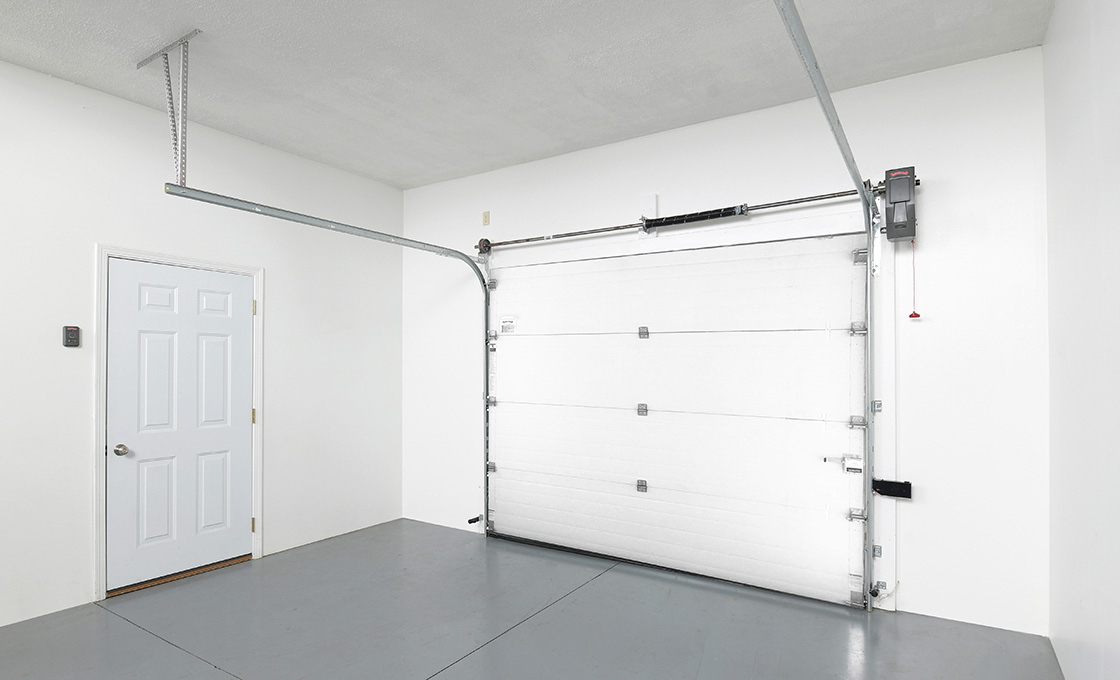 Overhead sectional industrial door installed in a warehouse opening