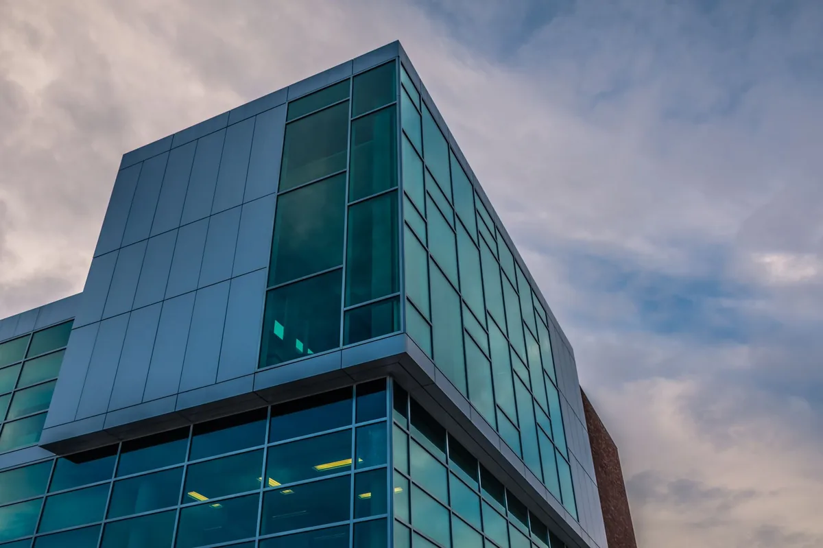 Modern industrial facility exterior showcasing architectural glass and aluminum entrance (Source: Pexels)