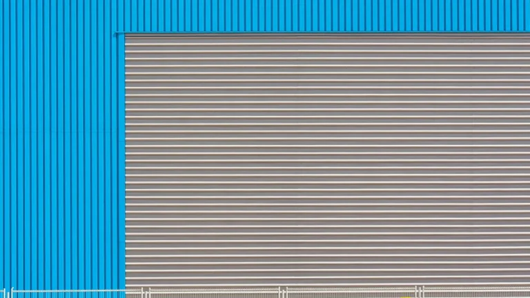 Industrial roller shutter door on a factory facade, the door type these chain motors drive