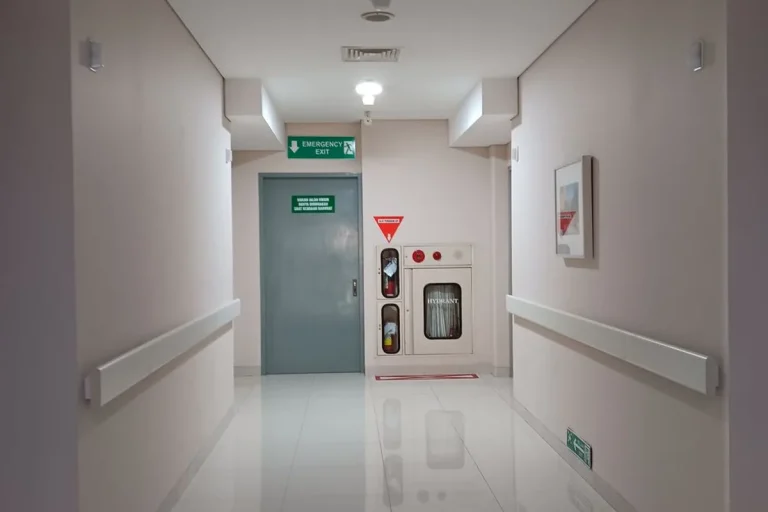 Cleanroom emergency exit door corridor view leading to safe egress route