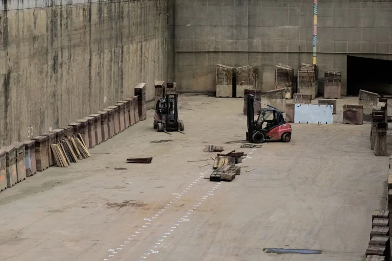 Forklift passing an open high-speed rapid roll door in a busy warehouse bay