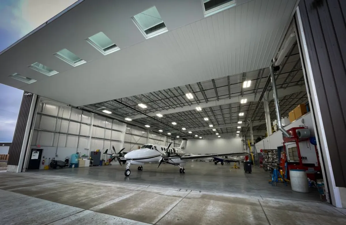 Wide-span hangar opening sized for industrial bi-folding doors