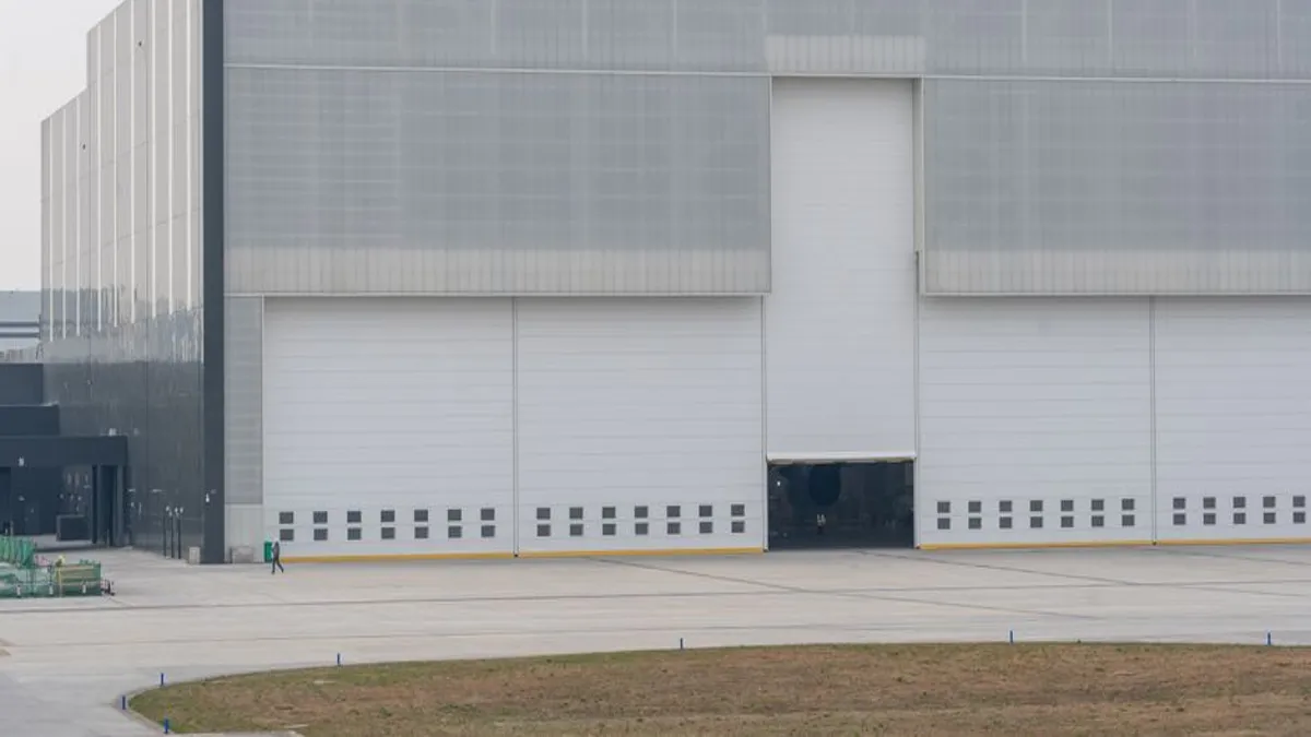 Warehouse exterior with wide industrial door bays for bi-folding doors