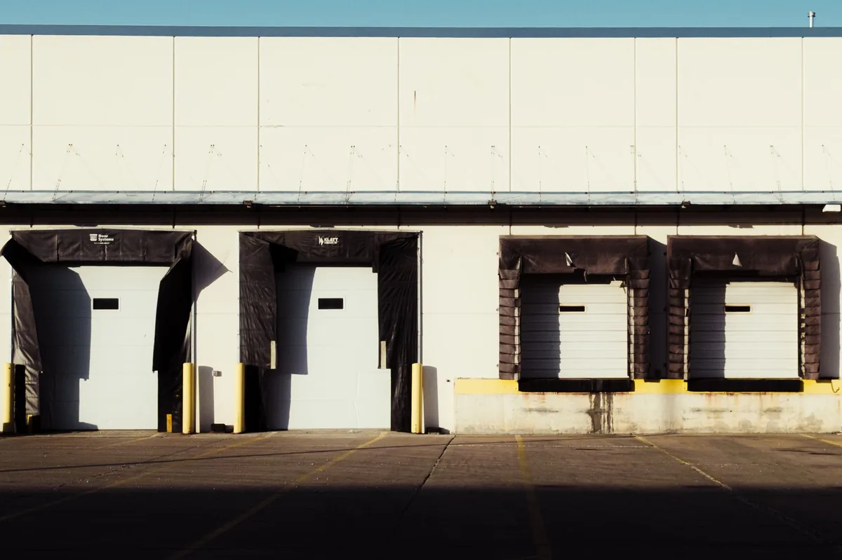 Industrial loading dock with closed bay doors awaiting changeover