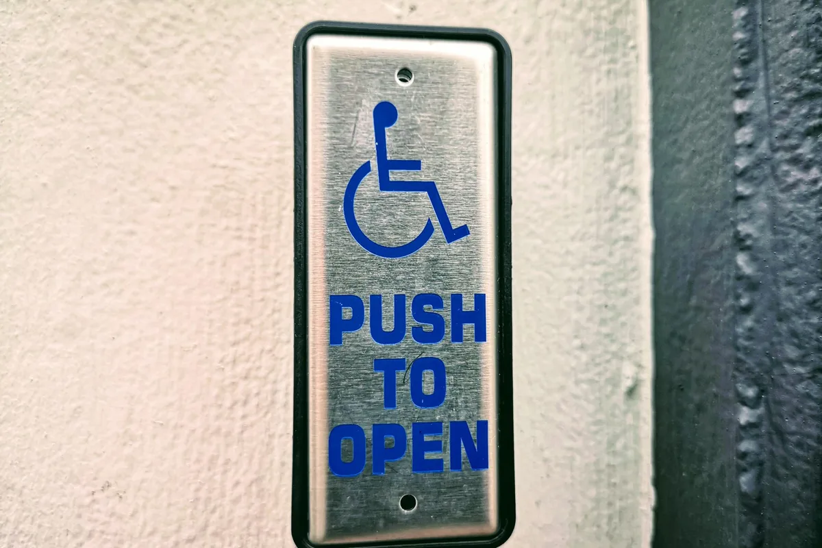 Wall-mounted push-to-open actuator plate giving one-motion door release