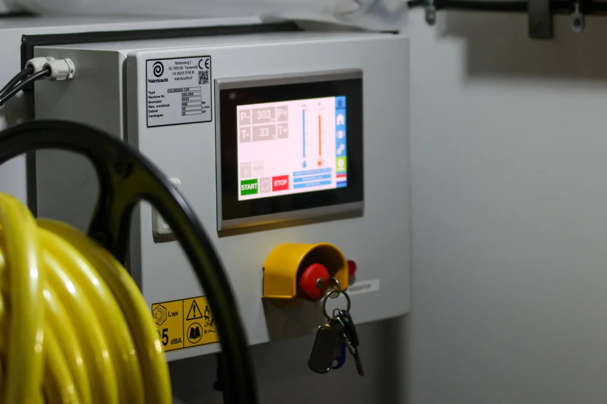 Emergency stop button and key-controlled override on an industrial control panel