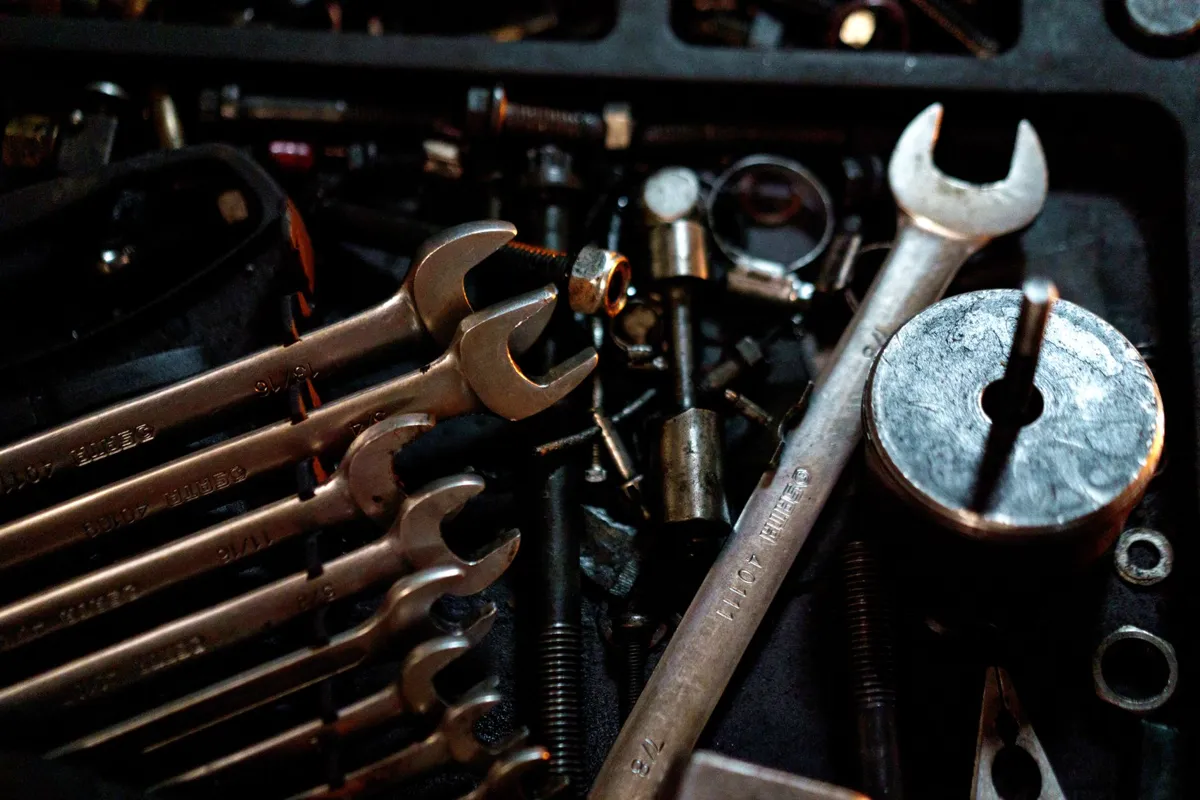 Winding bars and wrenches laid out for industrial door spring maintenance