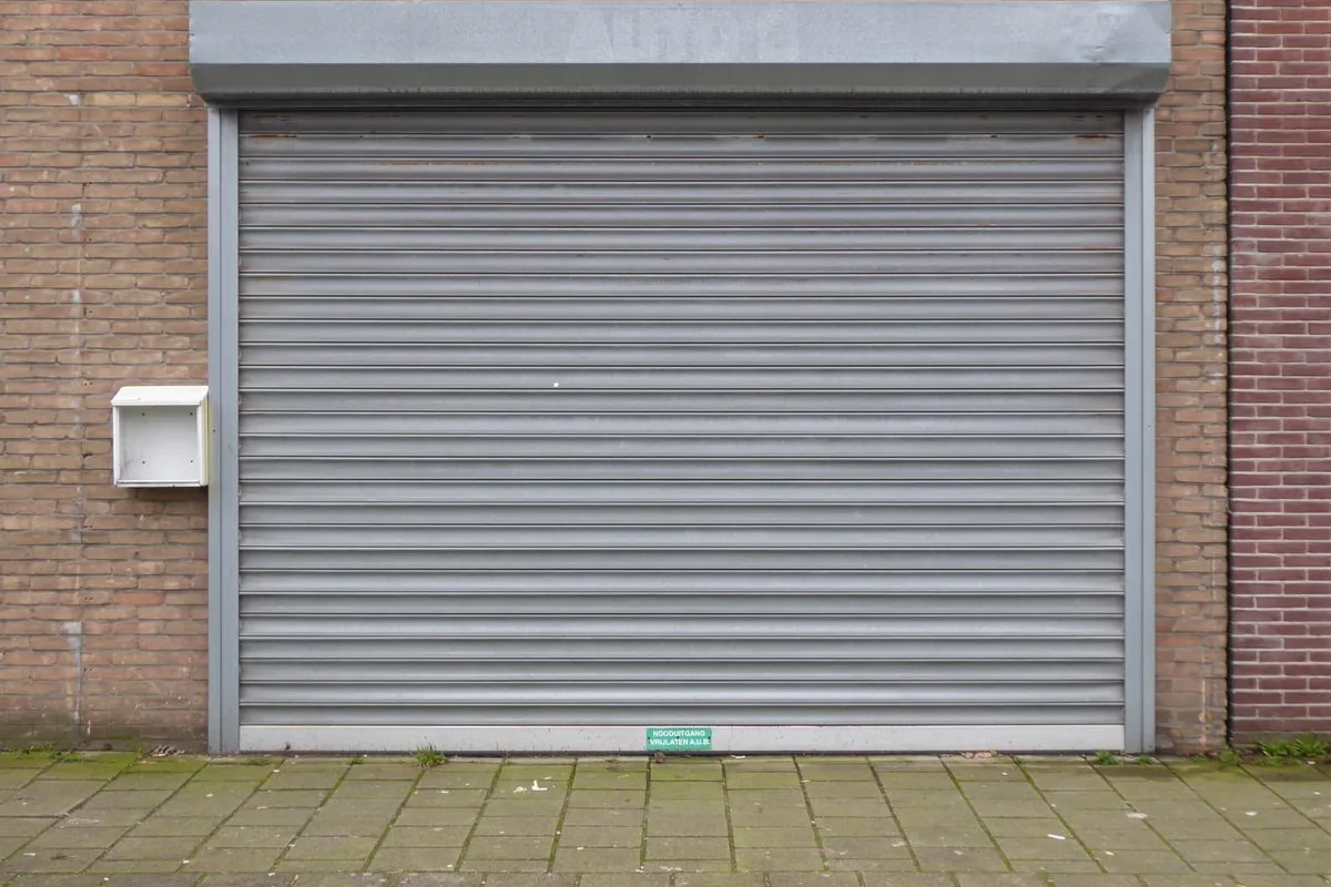 Close-up of horizontal steel slats on a closed grey roller shutter door
