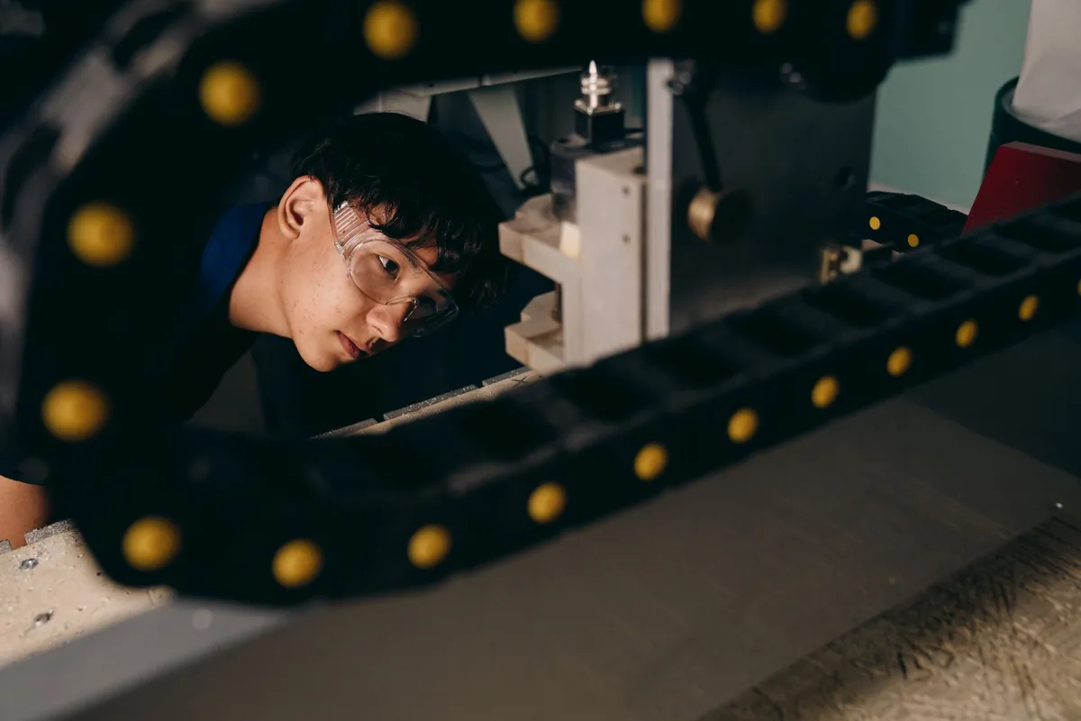 Engineer wearing goggles inspecting machinery during a door service visit