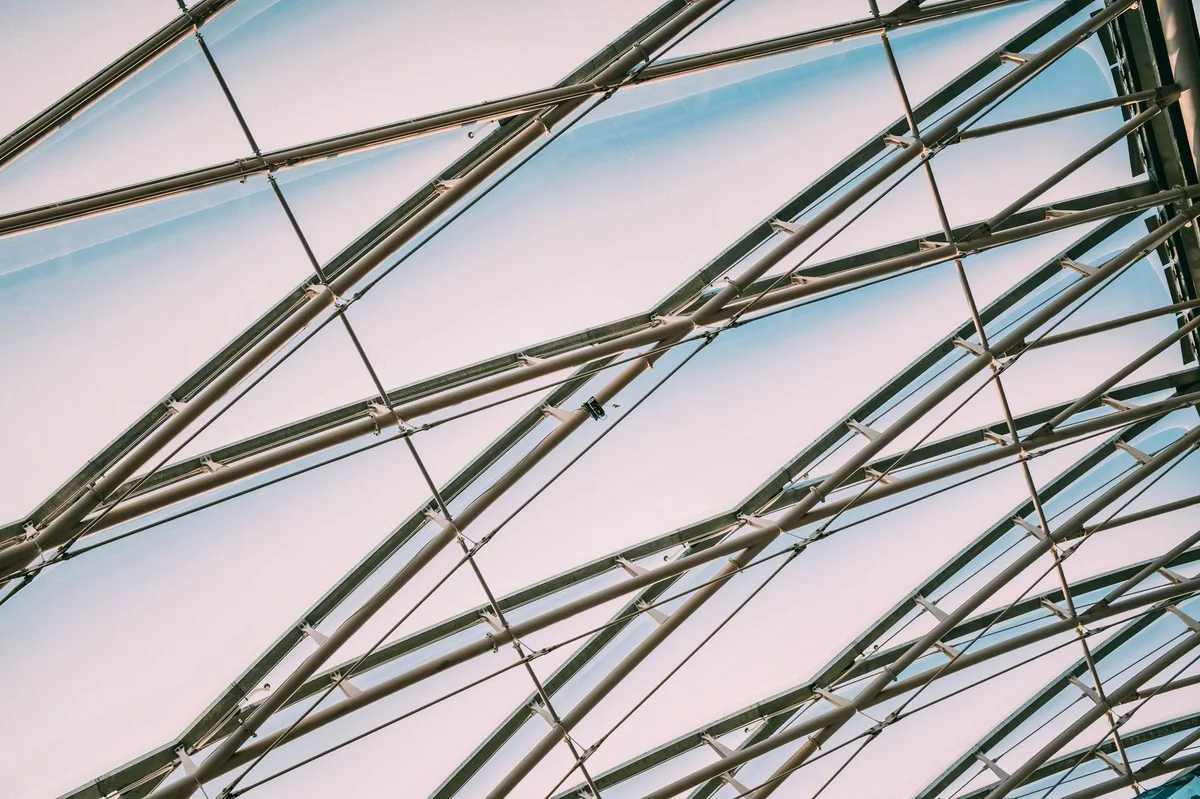 Structural steel box mullion overhead ceiling Unistrut grid tie-in anchors
